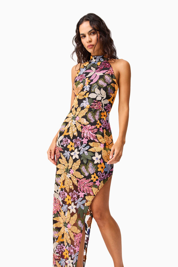 Brunette model wearing the Kiran Halter Gown in Orange Floral close up shot 