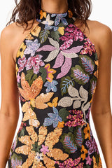Brunette model wearing the Kiran Halter Gown in Orange Floral detail shot 