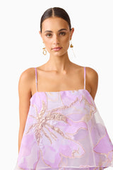 Brunette model wearing the Elysia Tiered Gown in Purple Floral detail posed shot