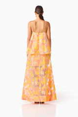 Brunette model wearing the Elysia Tiered Gown in Orange Floral back shot