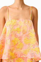 Brunette model wearing the Elysia Tiered Gown in Orange Floral detail shot