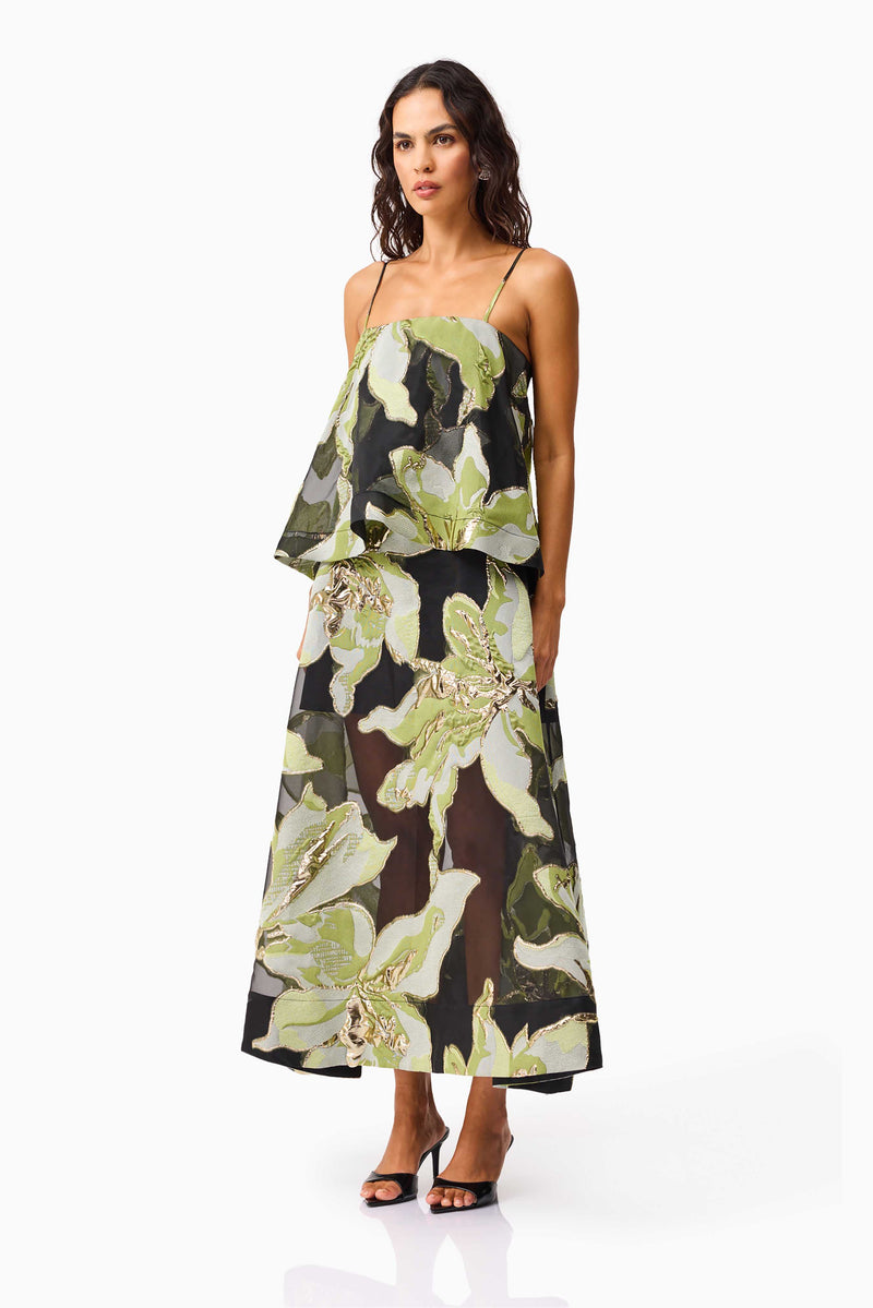Brunette model wearing the Elysia Tiered Gown in Black & Green Floral side shot