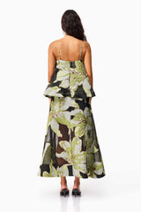 Brunette model wearing the Elysia Tiered Gown in Black & Green Floral back shot