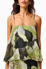 Brunette model wearing the Elysia Tiered Gown in Black & Green Floral detail shot