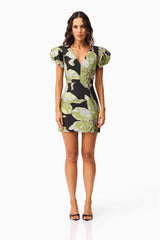 Brunette model wearing the Elysia Cap Sleeve Mini Dress in Black & Green Floral front shot