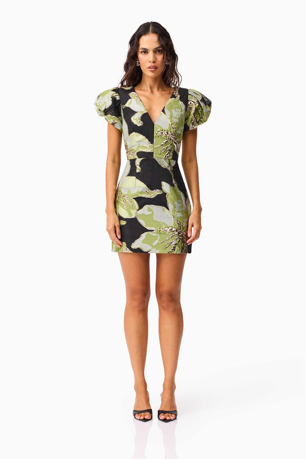 Brunette model wearing the Elysia Cap Sleeve Mini Dress in Black & Green Floral front shot