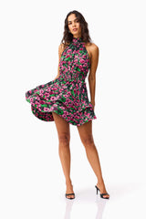 Brunette Model wearing the Estelle Halter Mini Dress in Black & Pink Floral posed shot