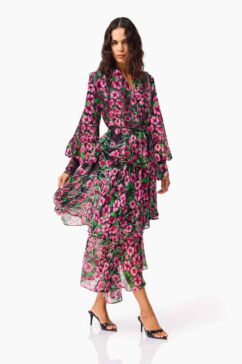 Brunette model wearing the Estelle Halter Mini Dress in Black & Pink Floral posed shot walking