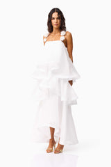 Brunette model wearing the Thalia Tiered Gown in White side shot 