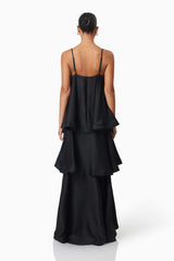 Brunette model wearing Tilly Tiered Maxi Dress in Black back shot