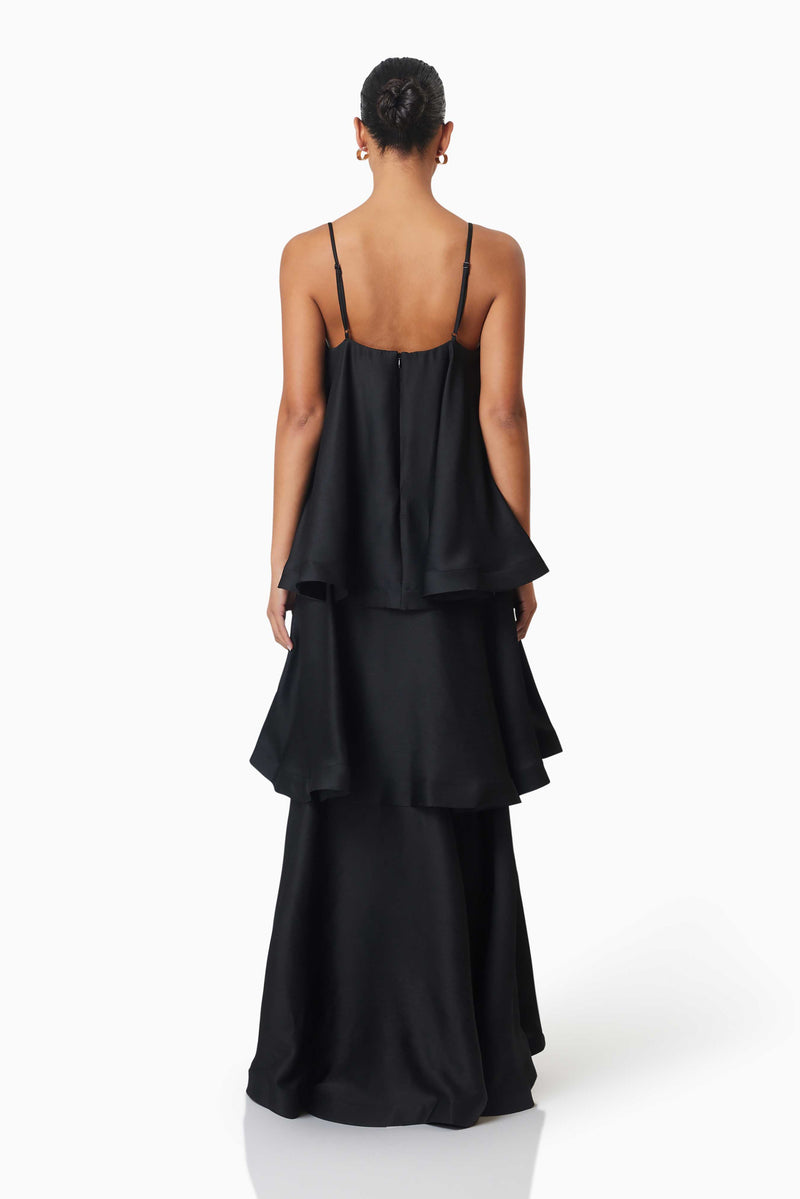 Brunette model wearing Tilly Tiered Maxi Dress in Black back shot