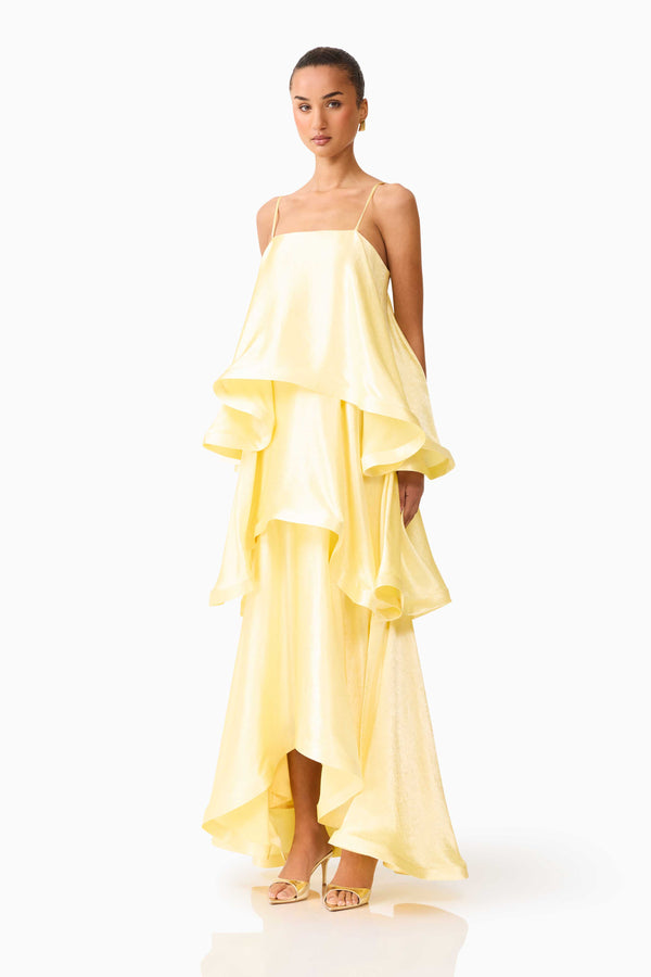 Brunette model wearing Tilly Tiered Maxi Dress in Butter Yellow side shot