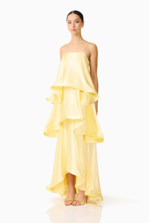 Brunette model wearing the Tilly Tiered Maxi Dress in Butter Yellow side shot 