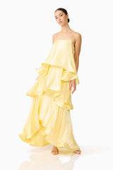 Brunette model wearing the Tilly Tiered Maxi Dress in Butter Yellow posed shot