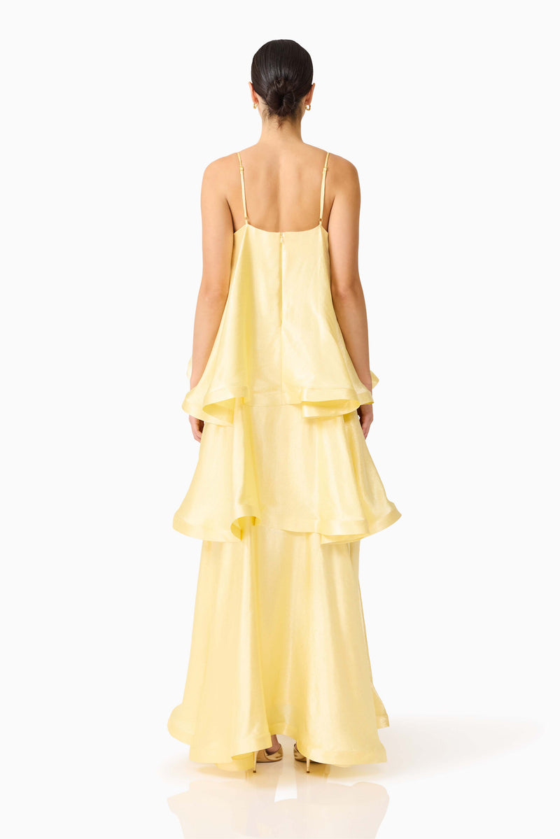 Brunette model wearing the Tilly Tiered Maxi Dress in Butter Yellow back shot