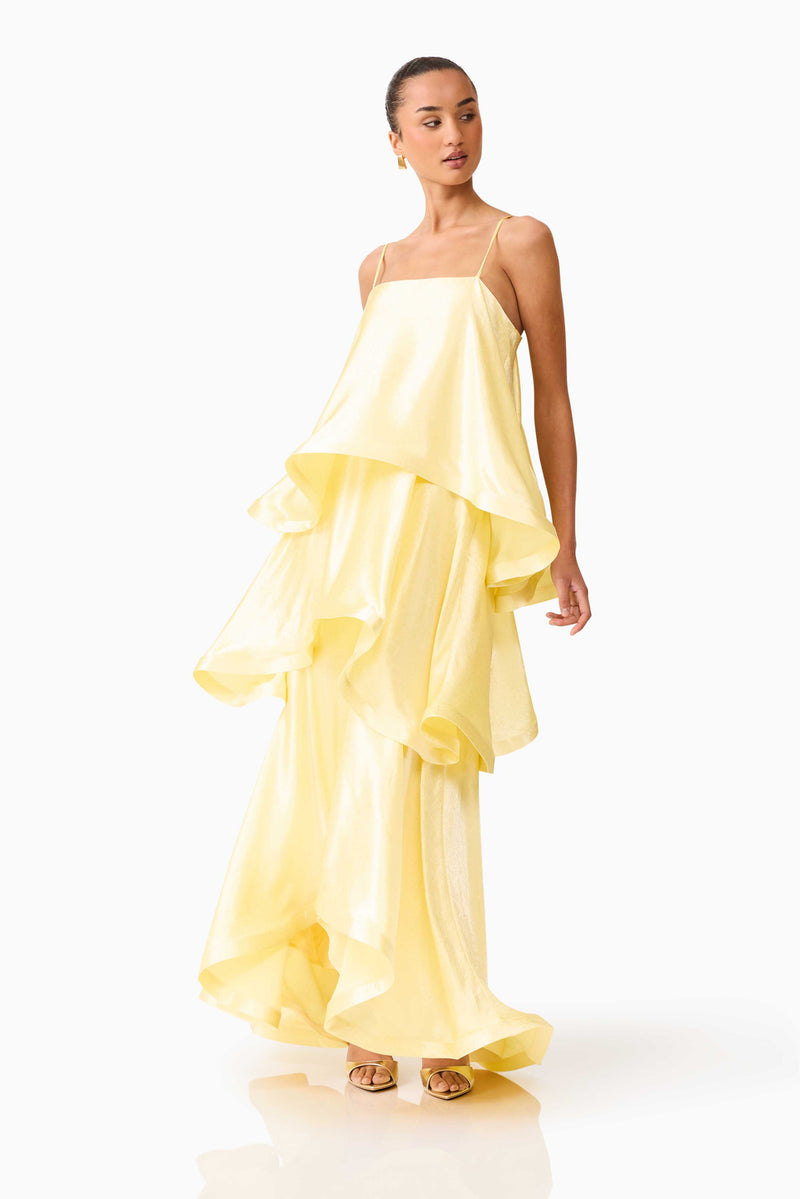 Brunette model wearing Tilly Tiered Maxi Dress in Butter Yellow side posed shot