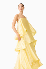Brunette model wearing the Tilly Tiered Maxi Dress in Butter Yellow posed looking away  shot