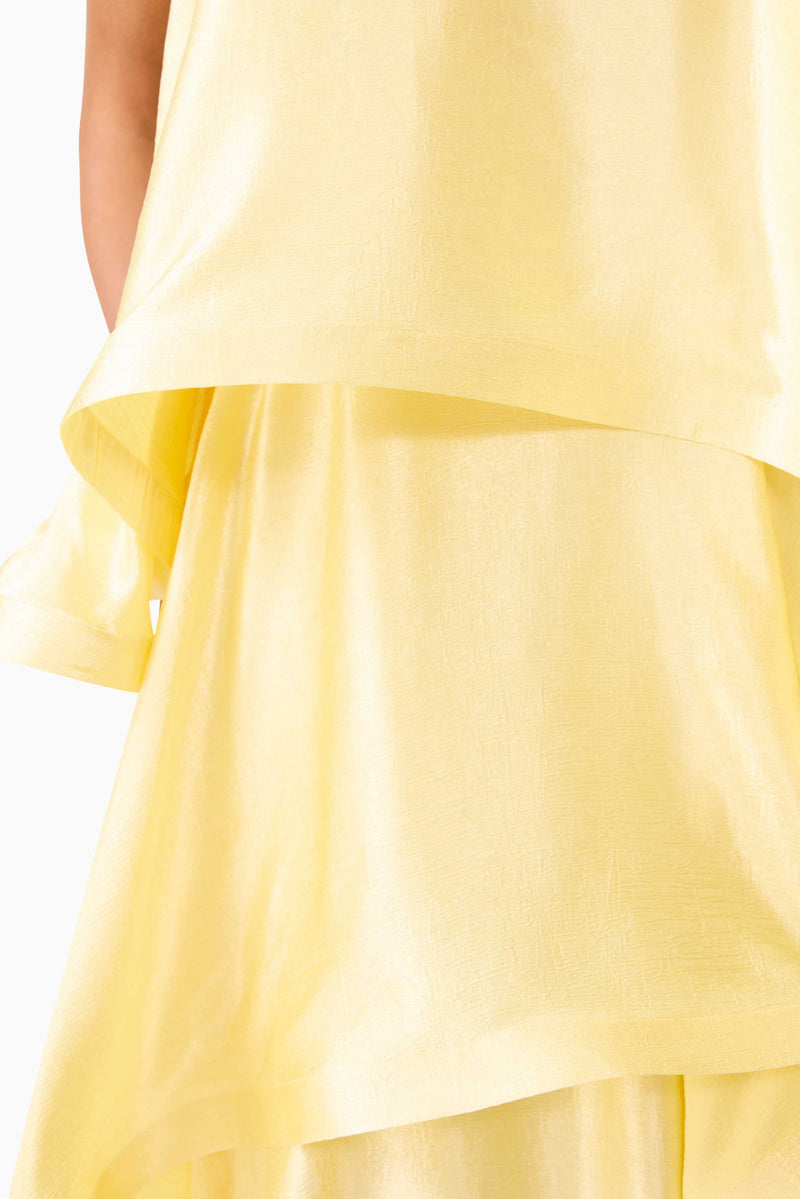 Brunette model wearing Tilly Tiered Maxi Dress in Butter Yellow fabric swatch