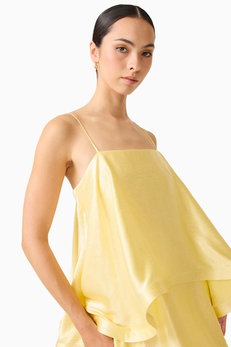 Brunette model wearing the Tilly Tiered Maxi Dress in Butter Yellow detail shot