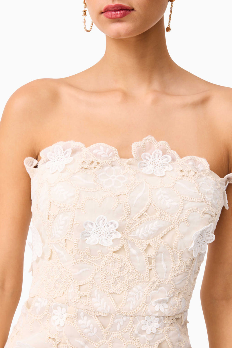 Brunette model wearing the Sienna Strapless Mini Dress in Cream detail shot