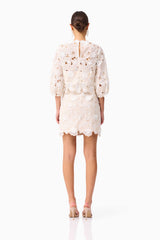 Brunette model wearing the Sienna Short Sleeve Top & Mini Skirt Set in Cream back shot