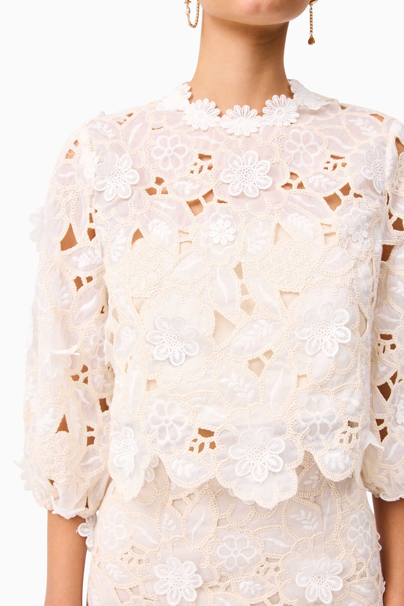 Brunette model wearing the Sienna Short Sleeve Top & Mini Skirt Set in Cream detail shot Top