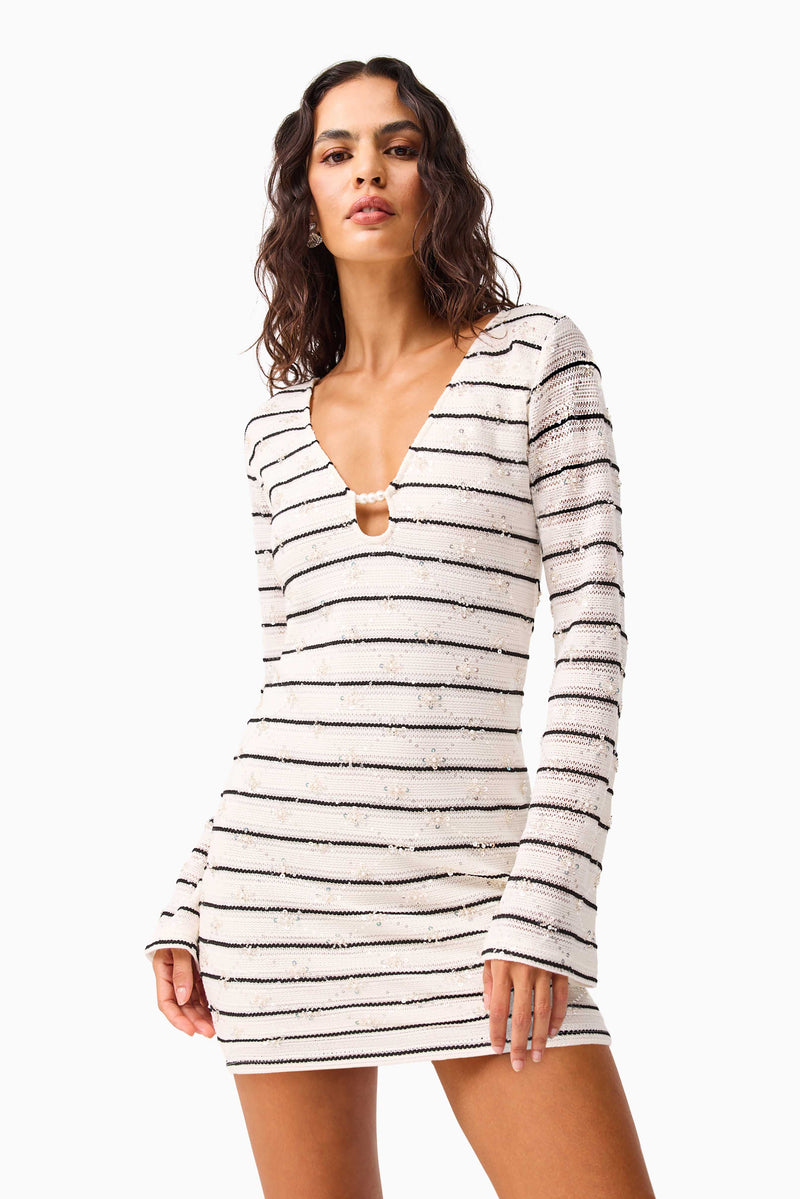 Brunette model wearing the Eldora Long Sleeve Mini Dress in Black & White close up shot