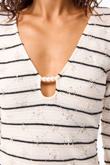 Brunette model wearing the Eldora Long Sleeve Mini Dress in Black & White detail shot