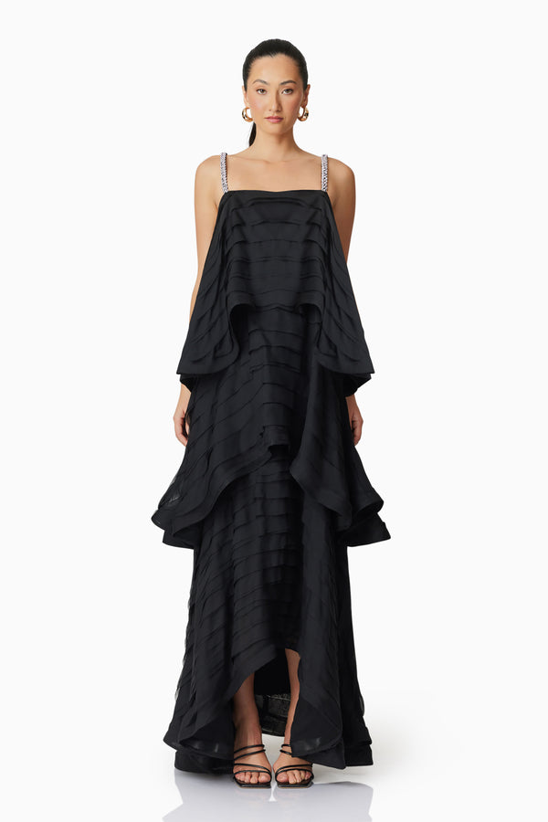 Brunette model wearing Eira Tiered Maxi Dress in Black front shot