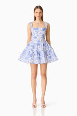 Brunette model wearing the Elin A-Line Mini Dress in Blue Floral front shot