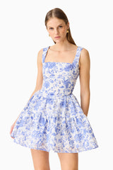 Brunette model wearing the Elin A-Line Mini Dress in Blue Floral close up shot
