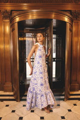Brunette model wearing the Elin Halter Gown in Blue Floral campaign shot