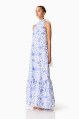 Brunette model wearing the Elin Halter Gown in Blue Floral side shot