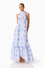 Brunette model wearing the Elin Halter Gown in Blue Floral posed shot