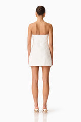 Brunette model wearing the Edelie Lace Mini Dress in White back shot