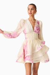 Brunette model wearing the Rova Long Sleeve Mini Dress in Cream & Pink Floral close up shot