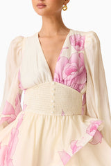 Brunette model wearing the Rova Long Sleeve Mini Dress in Cream & Pink Floral detail shot