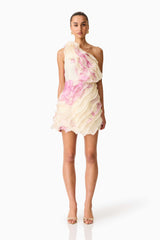 Brunette model wearing the Rova One Shoulder Mini Dress in Cream & Pink Floral front shot