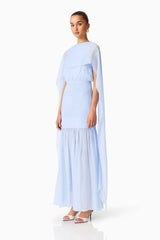 Brunette model wearing the Eliane Cape Gown in Blue side shot 