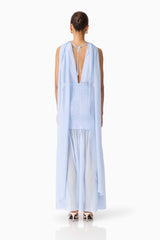 Brunette model wearing the Eliane Cape Gown in Blue back shot 