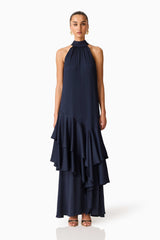 Brunette model wearing the Varella Halter Gown in Navy front shot
