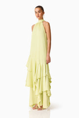 Brunette model wearing the Varella Halter Gown in Pistachio Green side shot 