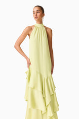 Brunette model wearing the Varella Halter Gown in Pistachio Green close up shot 