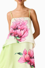 Brunette model wearing the Elisa Tiered Gown in Green & Pink Floral detail shot