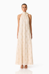 Brunette model wearing the Vessia Halter Neck Maxi Dress in Cream front shot