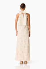 Brunette model wearing the Vessia Halter Neck Maxi Dress in Cream back shot