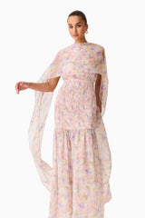 Brunette model wearing the Alinda Cape Gown in Pink Floral close up shot