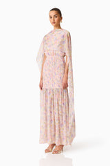 Brunette model wearing the Alinda Cape Gown in Pink Floral side shot