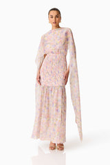 Brunette model wearing the Alinda Cape Gown in Pink Floral posed shot