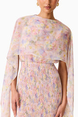 Brunette model wearing the Alinda Cape Gown in Pink Floral detail shot